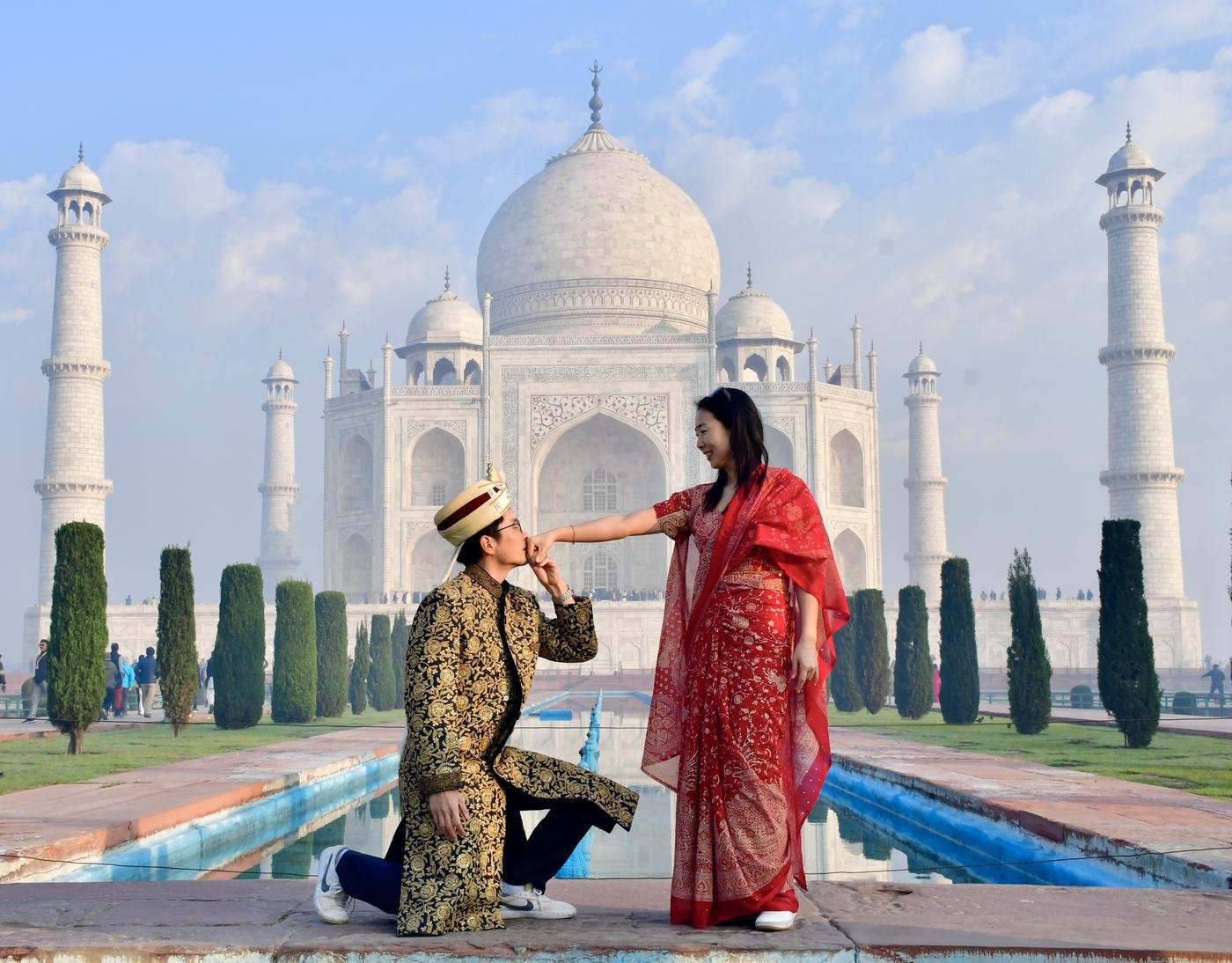 A pre-wedding couple in a romantic pose in front of the Taj Mahal