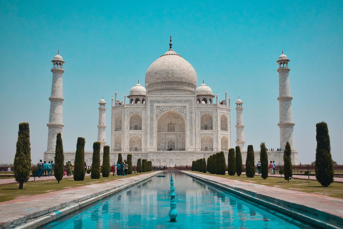 The Taj Mahal reflected in its pool under a clear blue sky